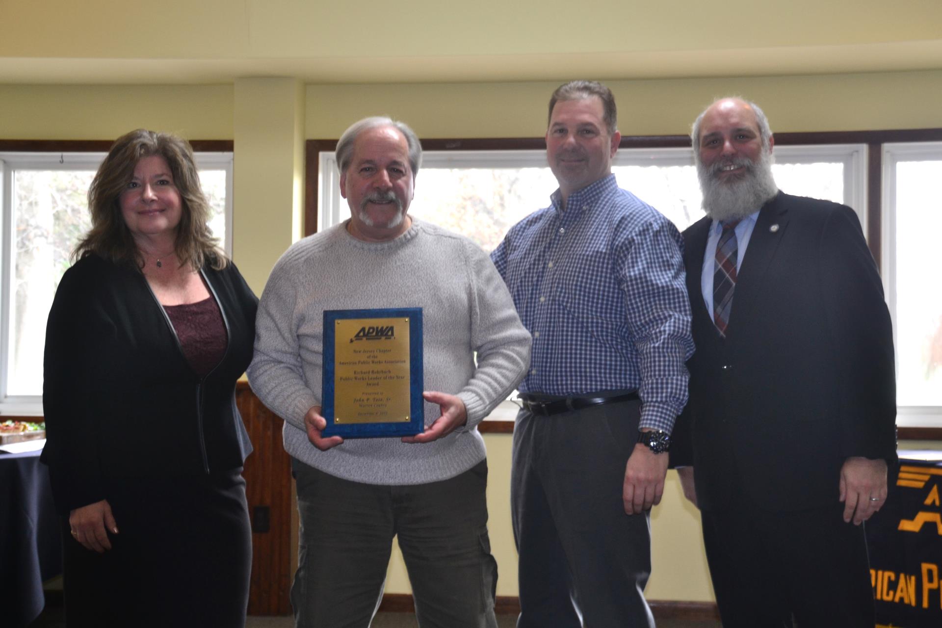 John Tate displays Public Works Leader of the Year award